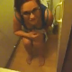 Some friends record a girl sitting on a toilet after bringing her some toilet paper. There is no indication of peeing or pooping.